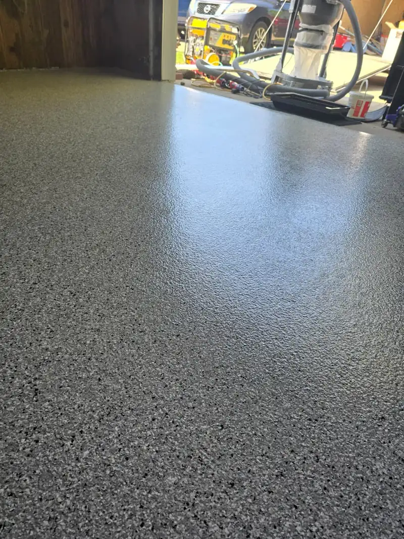 Glossy Feather Gray flake floor at the open garage door threshold in Allouez, WI