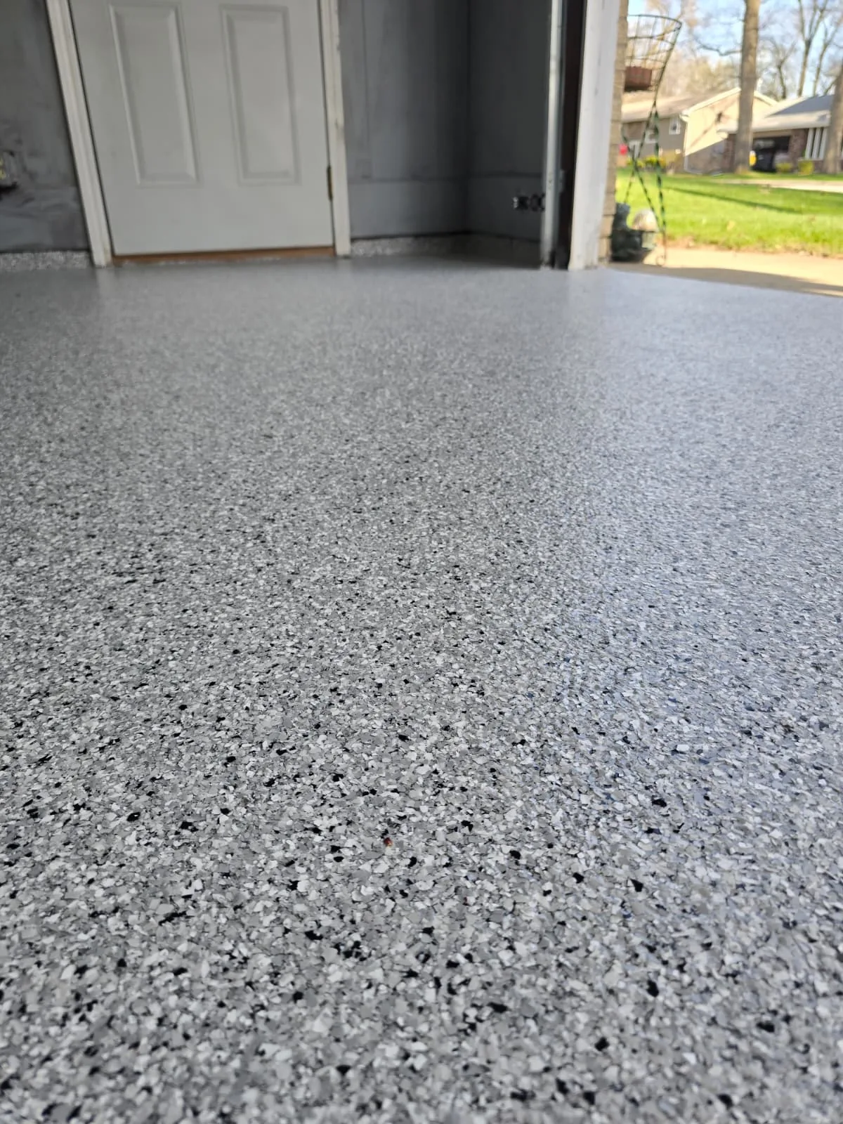 Flake epoxy garage floor near entry door
