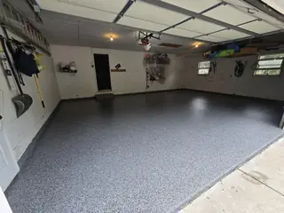 Gray flake epoxy garage floor with open door