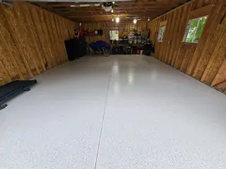 White flake epoxy floor in wood-framed garage