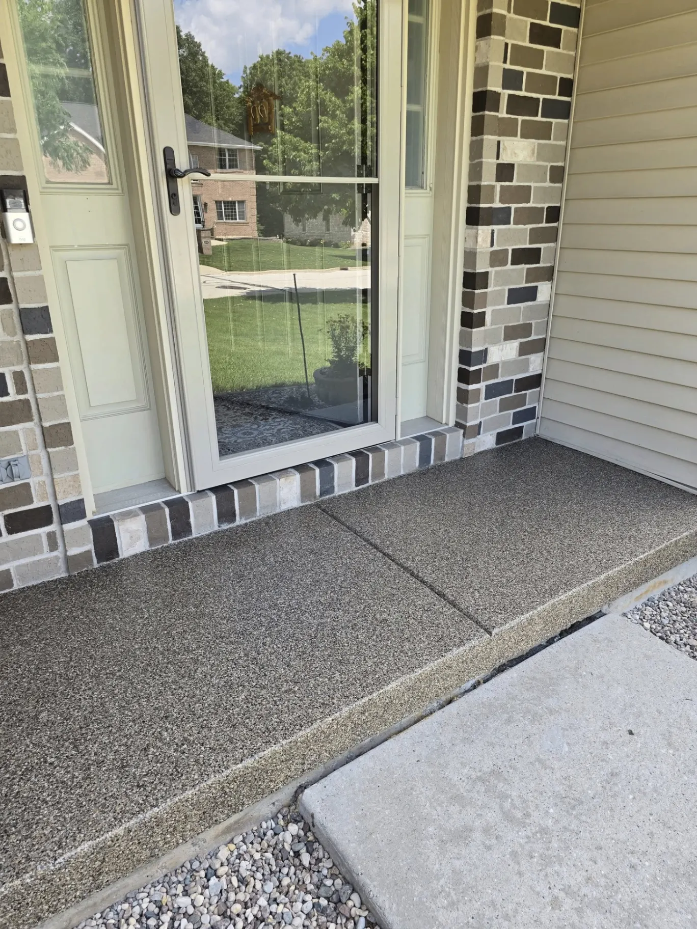 Close-up angle of coated front patio and steps