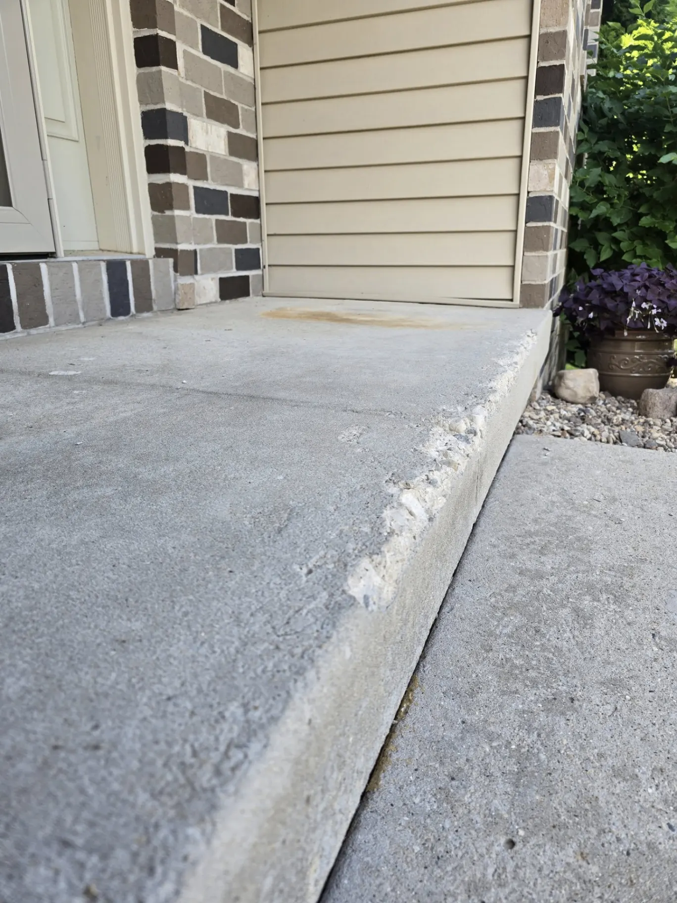 Worn concrete front porch slab before coating