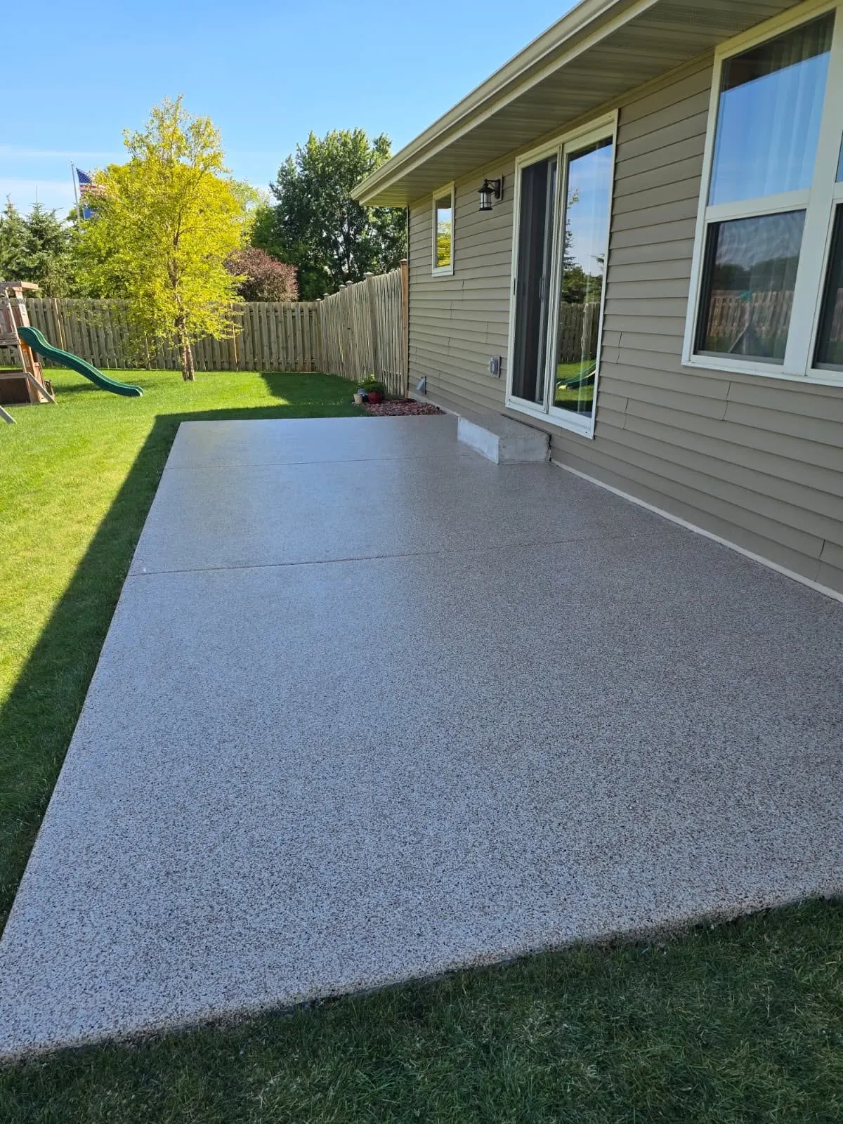 Finished decorative flake patio along back of home